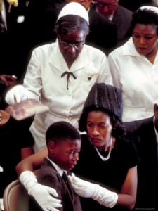 Myrlie Evers comforts her son at the funeral of her assassinated husband, Mississippi NAACP field organizer Medgar Evers