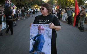 Adrianne DeSantis, the mother of Richard DeSantis, carrying a poster of her son during a demonstration. (The Press Democrat, 2007)
